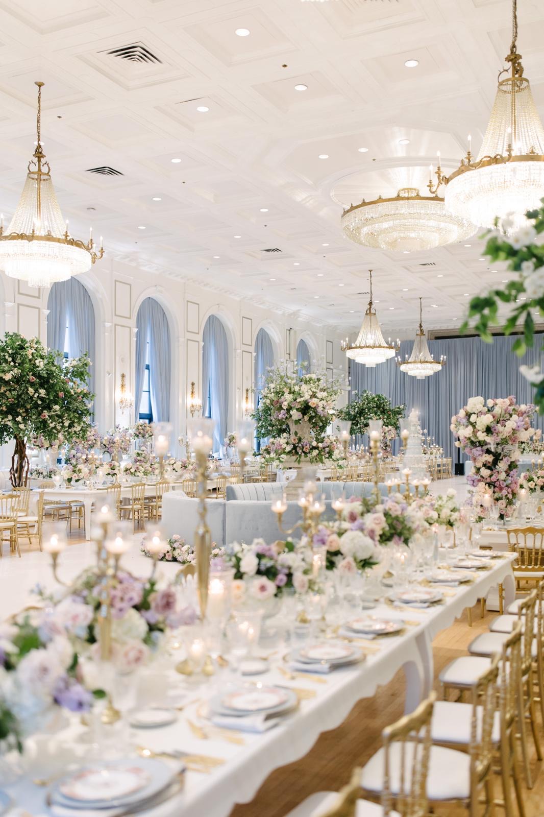 Lavender wedding reception tables beneath crystal chandeliers at Fairmont Royal York, Toronto